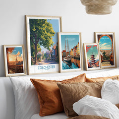 Framed travel posters of Paris, Colchester, Copenhagen, Tokyo, and Barcelona above a bed