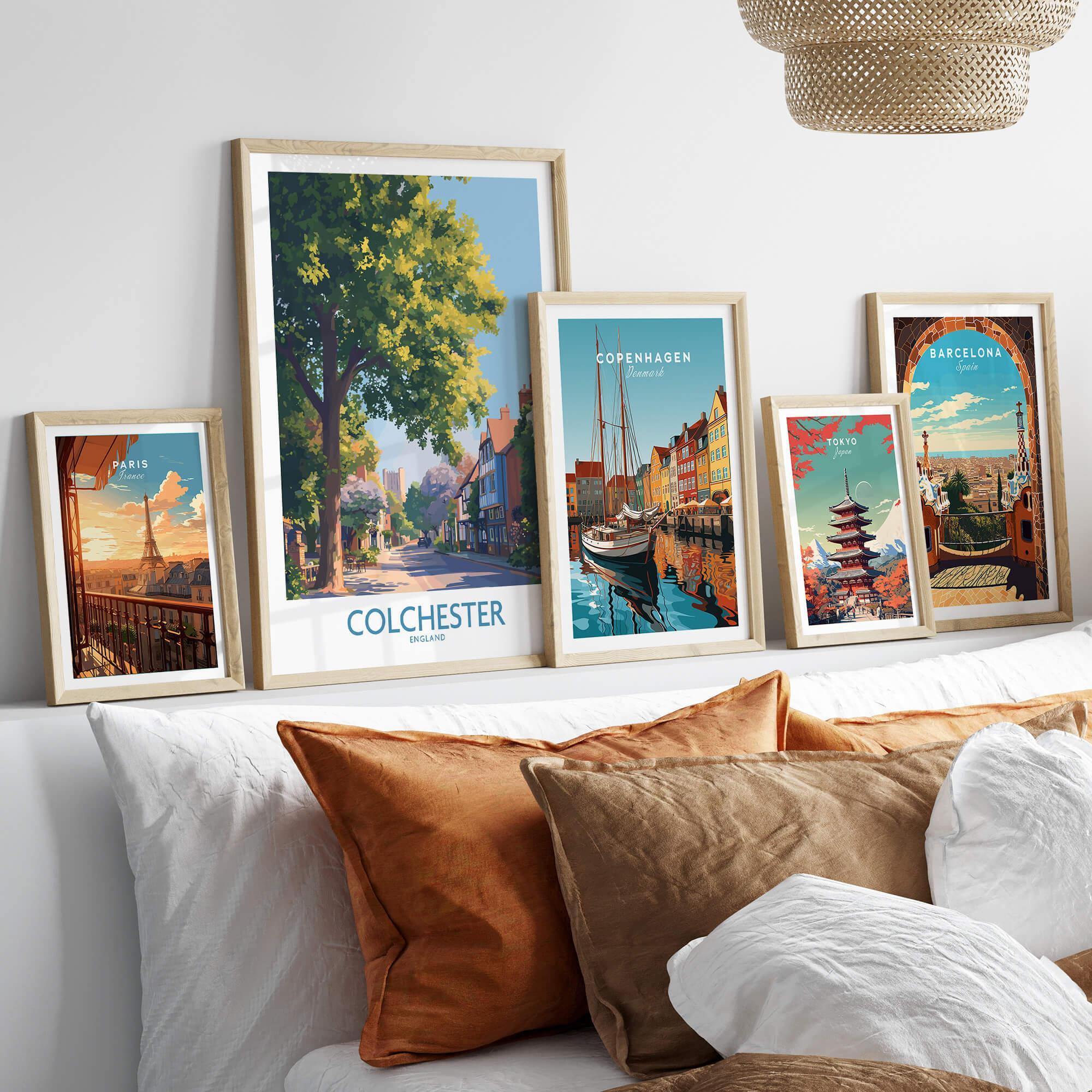 Framed travel posters of Paris, Colchester, Copenhagen, Tokyo, and Barcelona above a bed
