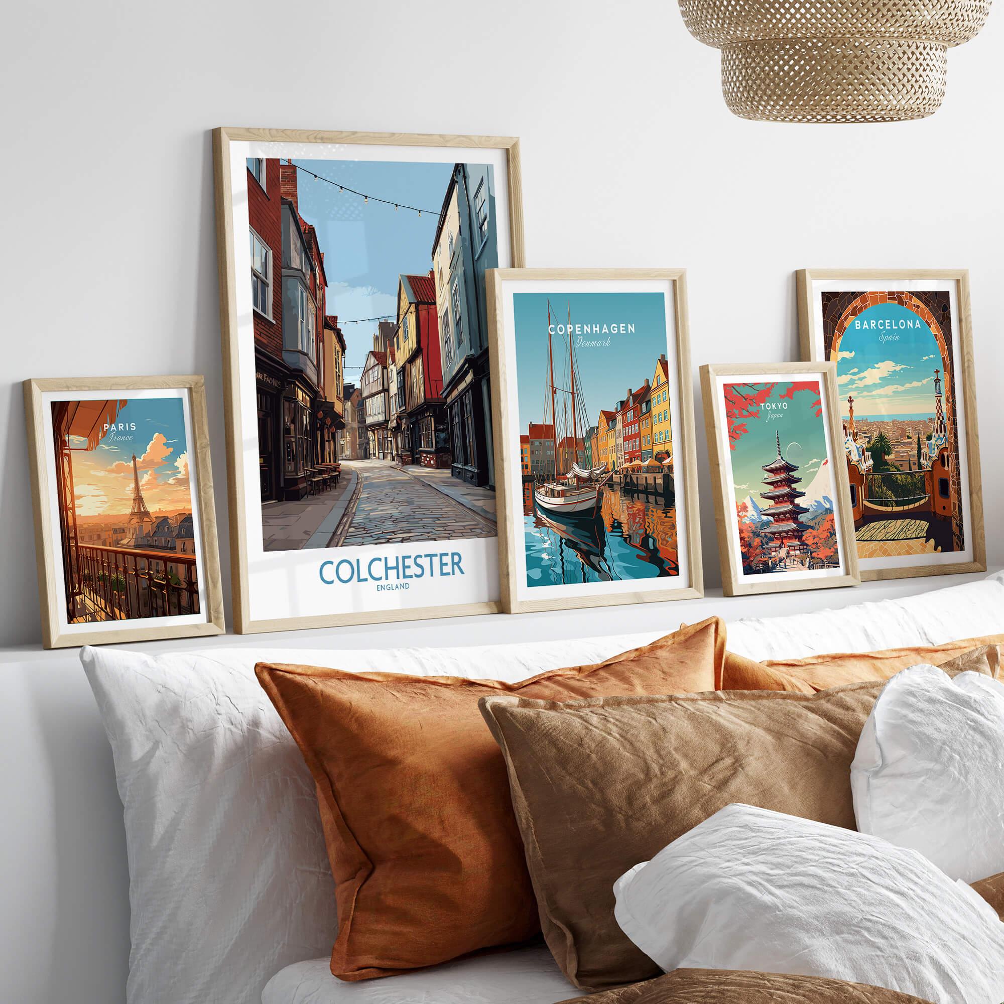Framed travel posters of Colchester, Paris, Copenhagen, Tokyo, and Barcelona above bed
