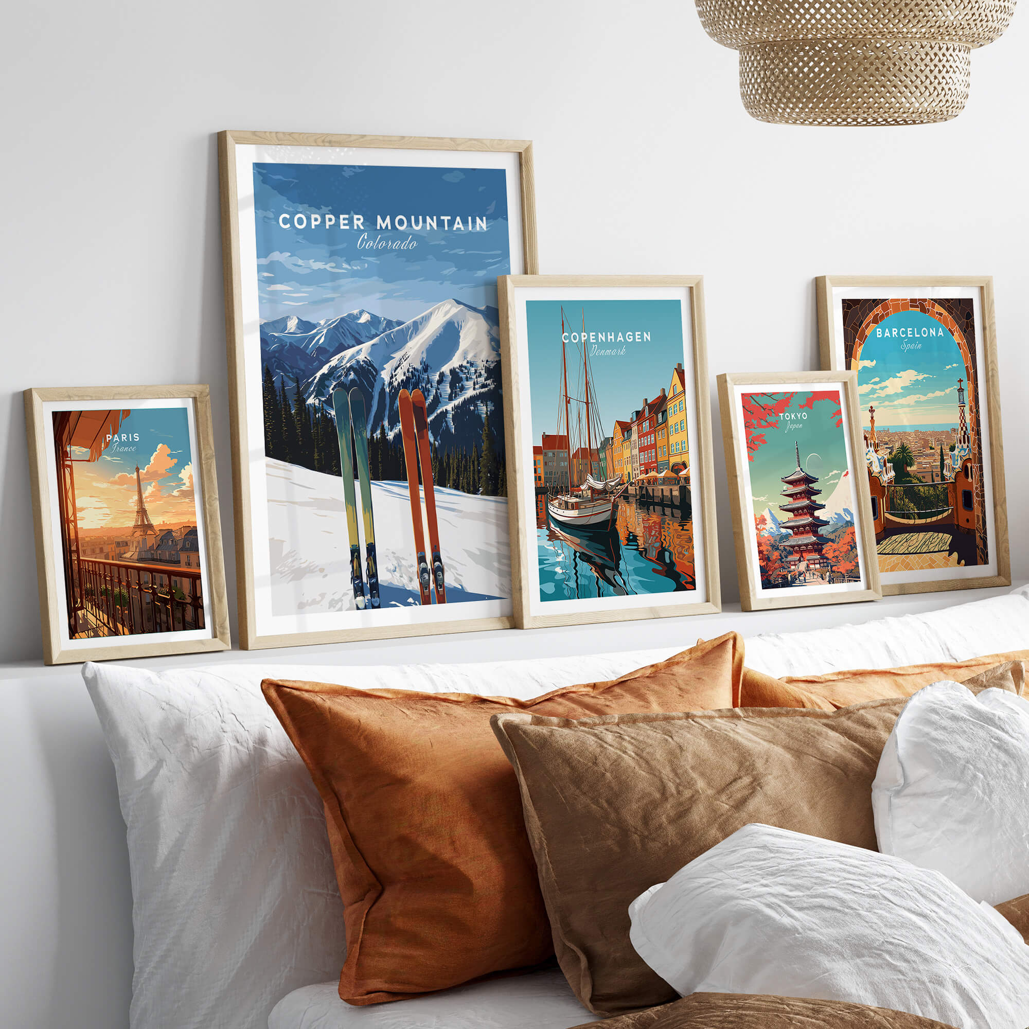 Copper Mountain Travel Poster – Colorado Mountain Summit & Ski Art Print displayed among other travel posters on a cozy couch.