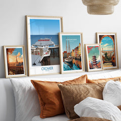 Cromer Norfolk Wall Art – Historic Seaside Pier Art Print displayed among other vibrant city art prints on a sofa.