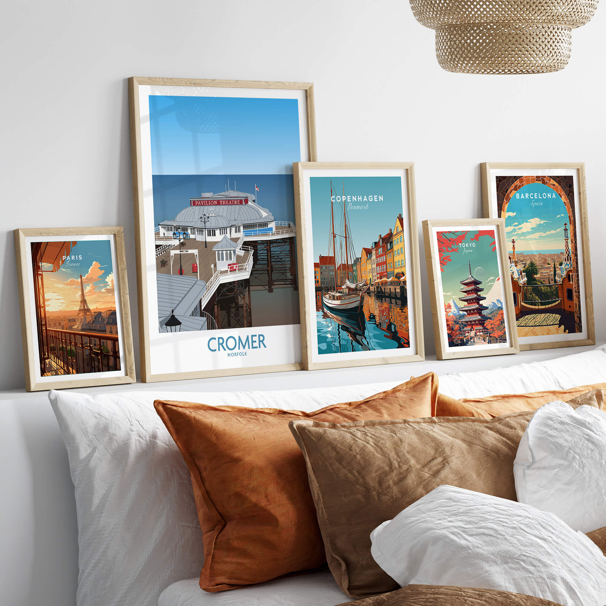 Cromer Norfolk Wall Art – Historic Seaside Pier Art Print displayed among other vibrant city art prints on a sofa.