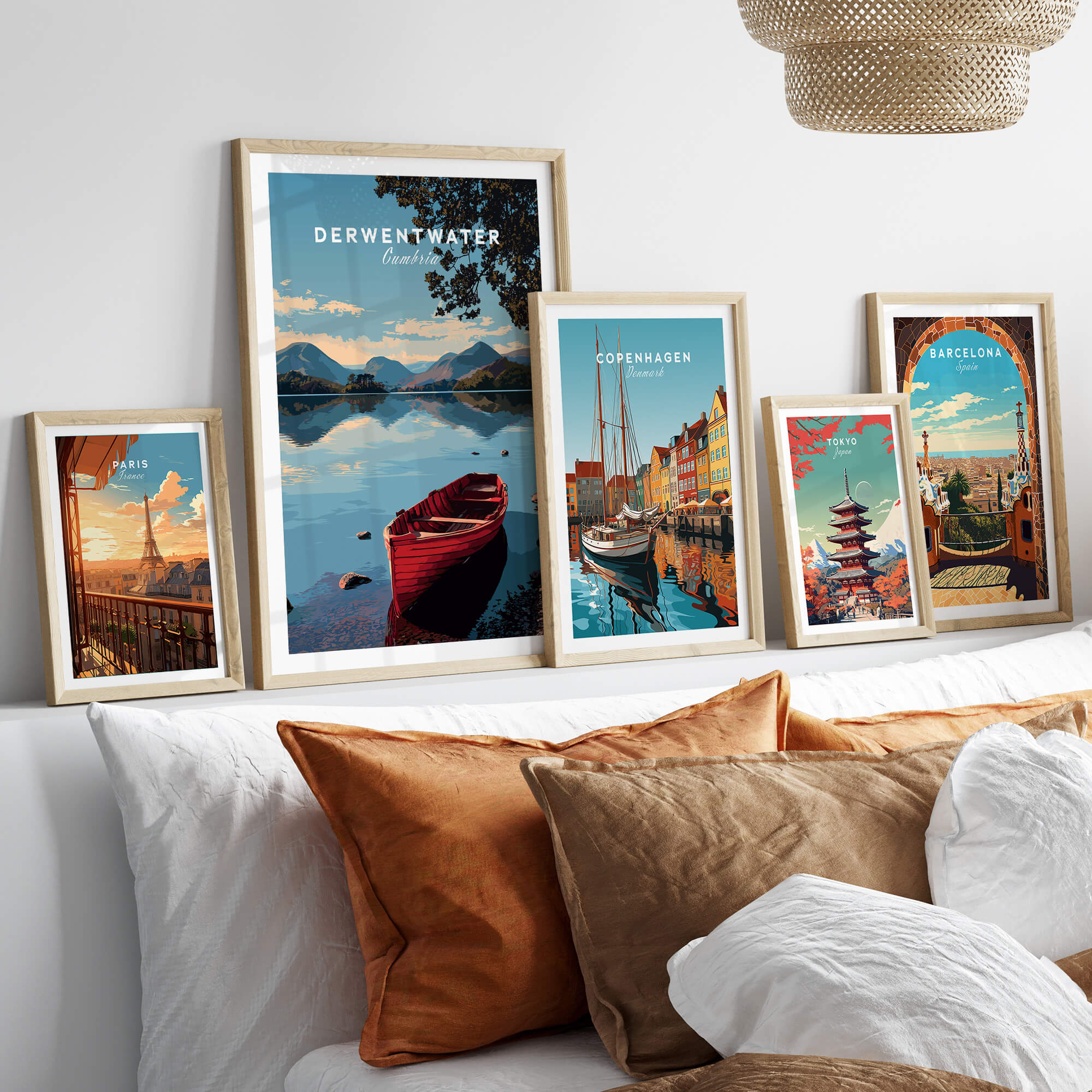 Derwentwater Travel Poster – Lake District Art Print displayed among framed travel posters on a cozy sofa.