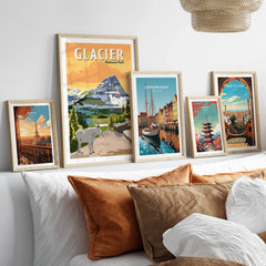 Framed travel posters and national park prints above bed, modern home decor wall art