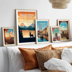 Set of five framed travel posters above bed, featuring Grand Teton, Paris, Copenhagen, Tokyo, Barcelona.