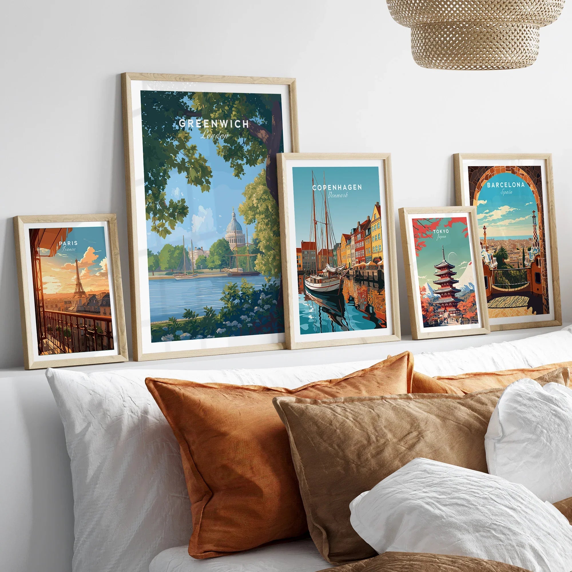 Framed travel posters of Paris, Greenwich, Copenhagen, Tokyo, and Barcelona above bed