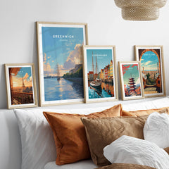 Framed travel posters of Paris, Greenwich, Copenhagen, Tokyo, and Barcelona above bed