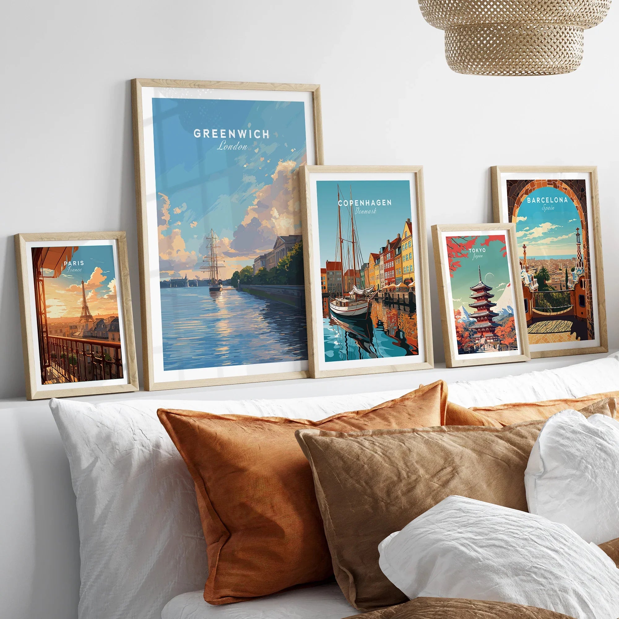 Framed travel posters of Paris, Greenwich, Copenhagen, Tokyo, and Barcelona above bed