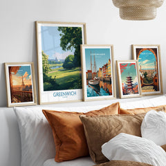 Set of five framed travel posters with city and nature scenes above a modern bed.