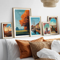 Framed travel posters of Paris, Greenwich, Copenhagen, Tokyo, and Barcelona above bed
