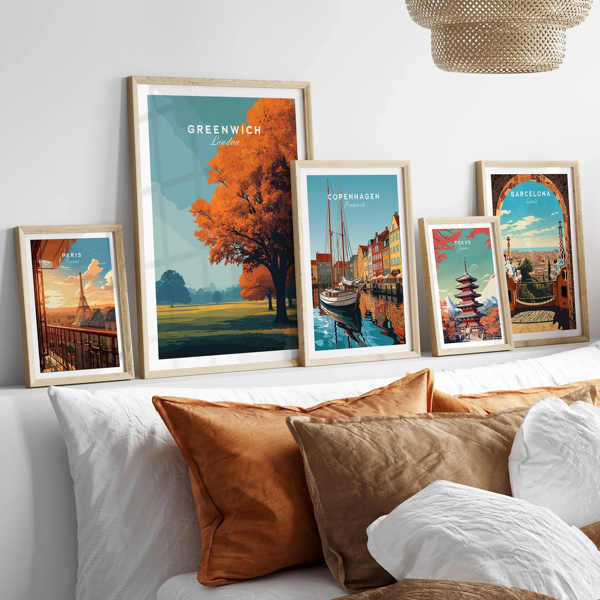 Framed travel posters of Paris, Greenwich, Copenhagen, Tokyo, and Barcelona above bed