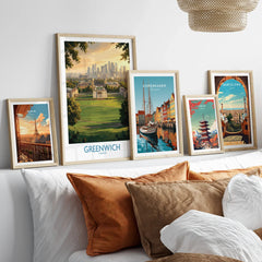Set of five framed travel posters above bed, featuring city skylines and landmarks.