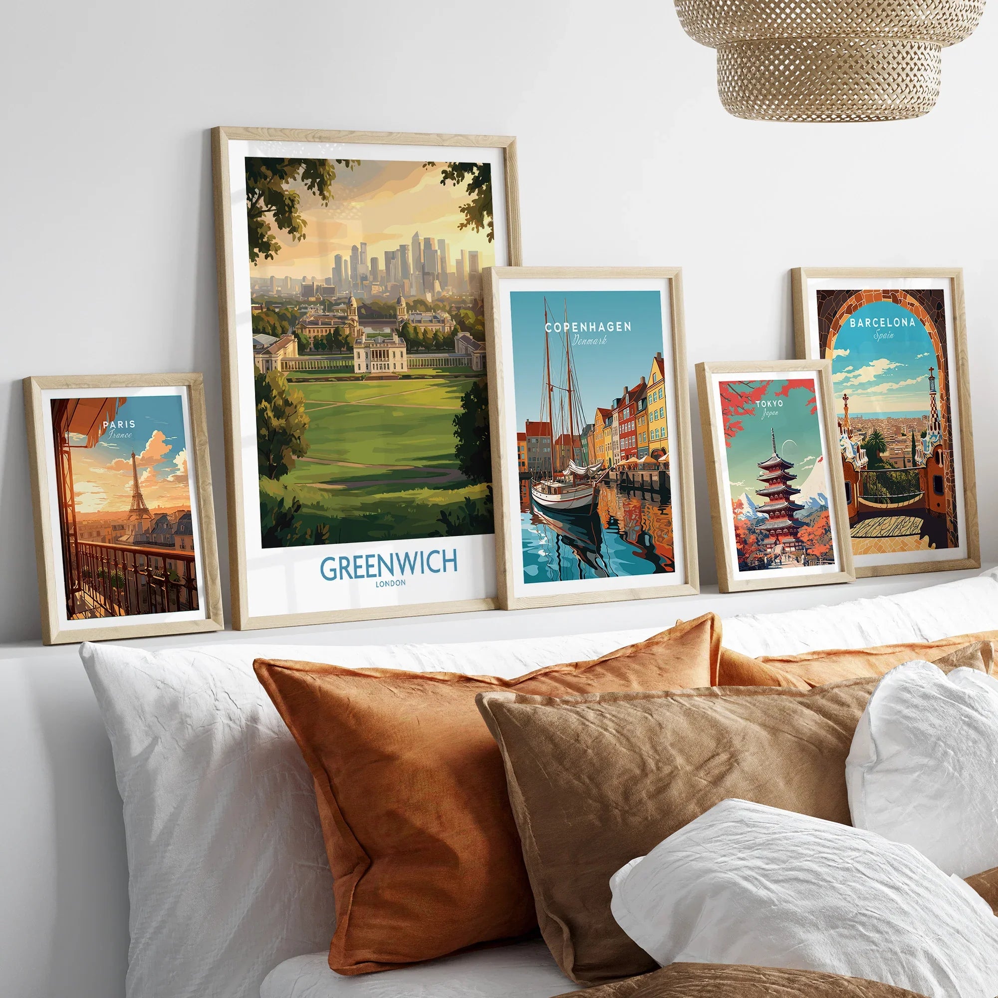 Set of five framed travel posters above bed, featuring city skylines and landmarks.