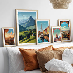 Gruyères Switzerland Travel Poster | Mountain Landscape Wall Art Print displayed among other travel posters on a cozy sofa.