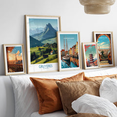 Gruyères Switzerland Canvas Print | Charming Swiss Countryside Scenery Poster displayed among other city posters on a couch.