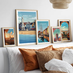 Herne Bay Kent Wall Art Print | British Travel Poster framed among other travel posters on a stylish sofa.