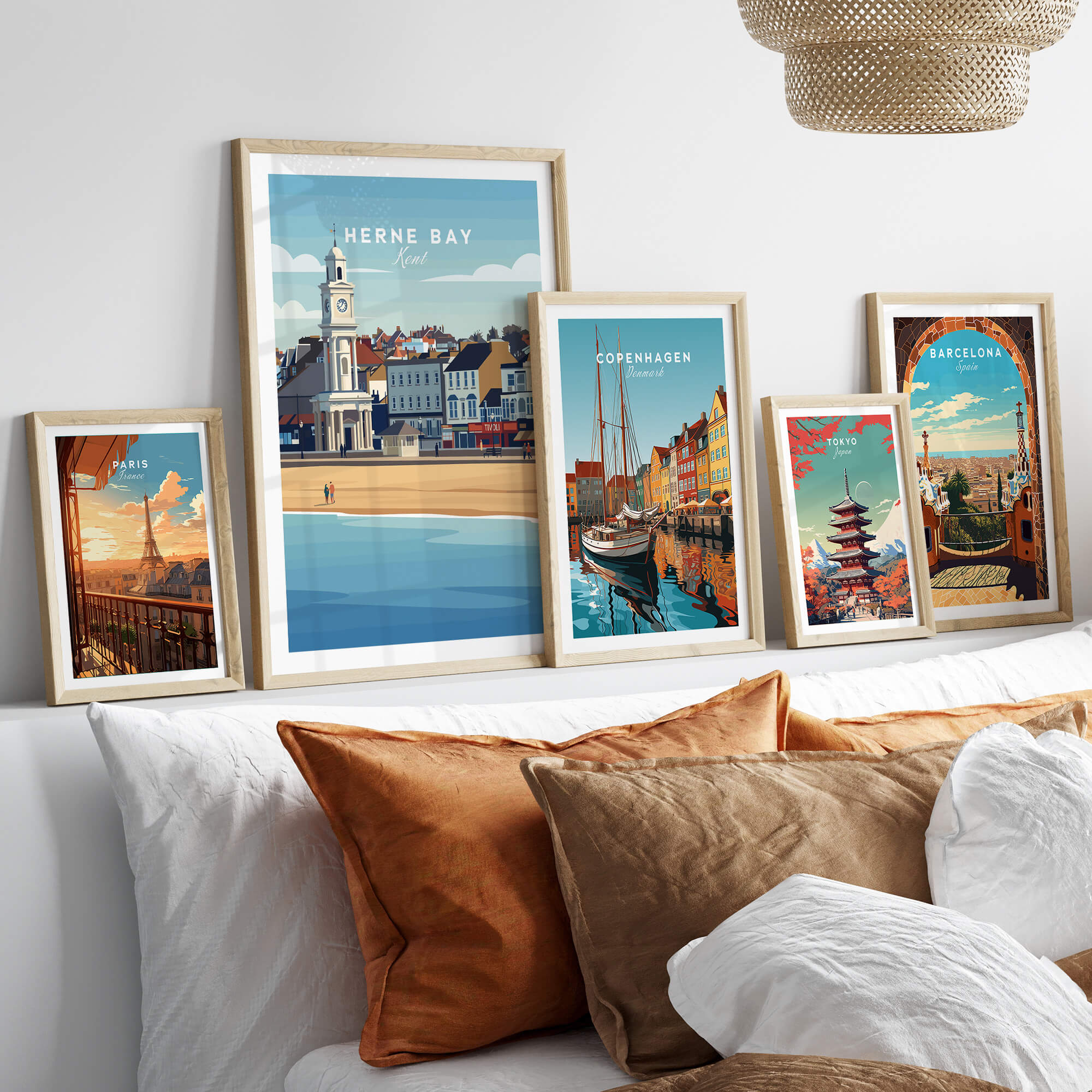 Herne Bay Kent Wall Art Print | British Travel Poster framed among other travel posters on a stylish sofa.