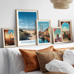 Holkham Beach Norfolk Poster | Serene Coastal Landscape Canvas Print displayed among other travel posters on a stylish sofa.