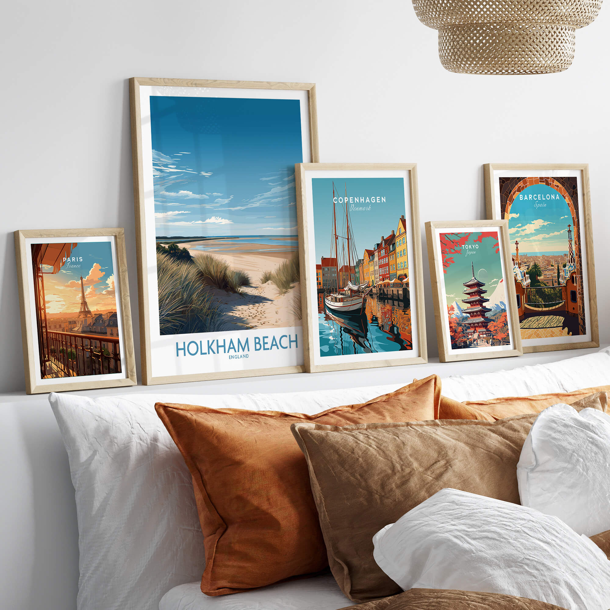 Holkham Beach Norfolk Poster | Serene Coastal Landscape Canvas Print displayed among other travel posters on a stylish sofa.