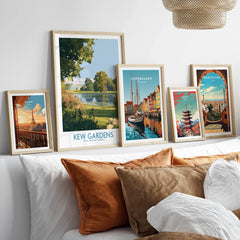 Set of five framed travel art prints above bed, featuring Paris, Kew Gardens, Copenhagen, Tokyo, Barcelona.