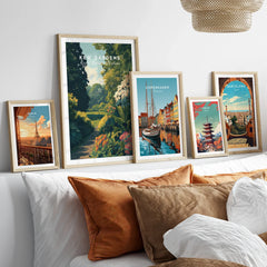 Set of five framed travel posters above bed, featuring Paris, Kew Gardens, Copenhagen, Tokyo, and Barcelona.