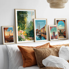 Framed travel art prints of Kew Gardens, Paris, Copenhagen, Tokyo, Barcelona above a bed