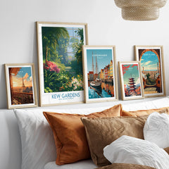 Set of five framed travel art prints above bed, featuring Paris, Kew Gardens, Copenhagen, Tokyo, and Barcelona.