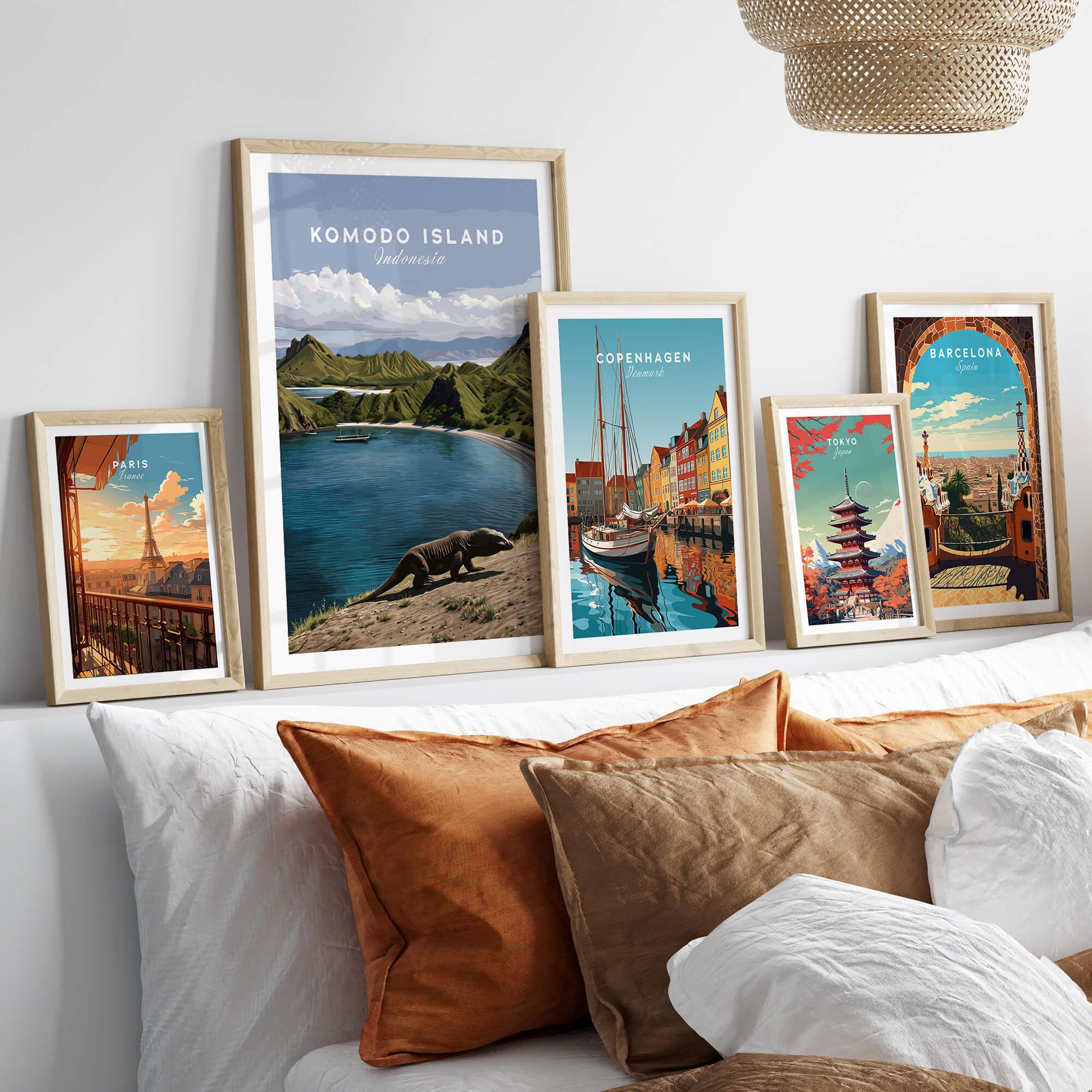 Framed travel posters featuring Paris, Komodo Island, Copenhagen, Tokyo, and Barcelona above bed