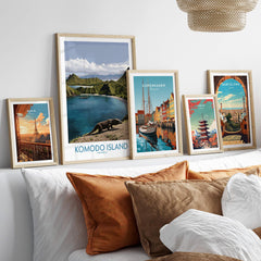 Set of five framed travel posters above bed, featuring Paris, Komodo Island, Copenhagen, Tokyo, and Barcelona.