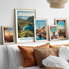 Framed travel posters of Paris, Komodo Island, Copenhagen, Tokyo, and Barcelona above bed