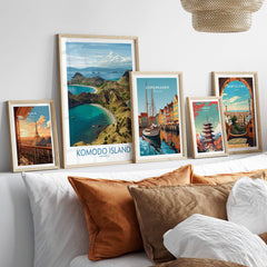 Framed travel posters of Komodo Island, Paris, Copenhagen, Tokyo, and Barcelona above a bed.