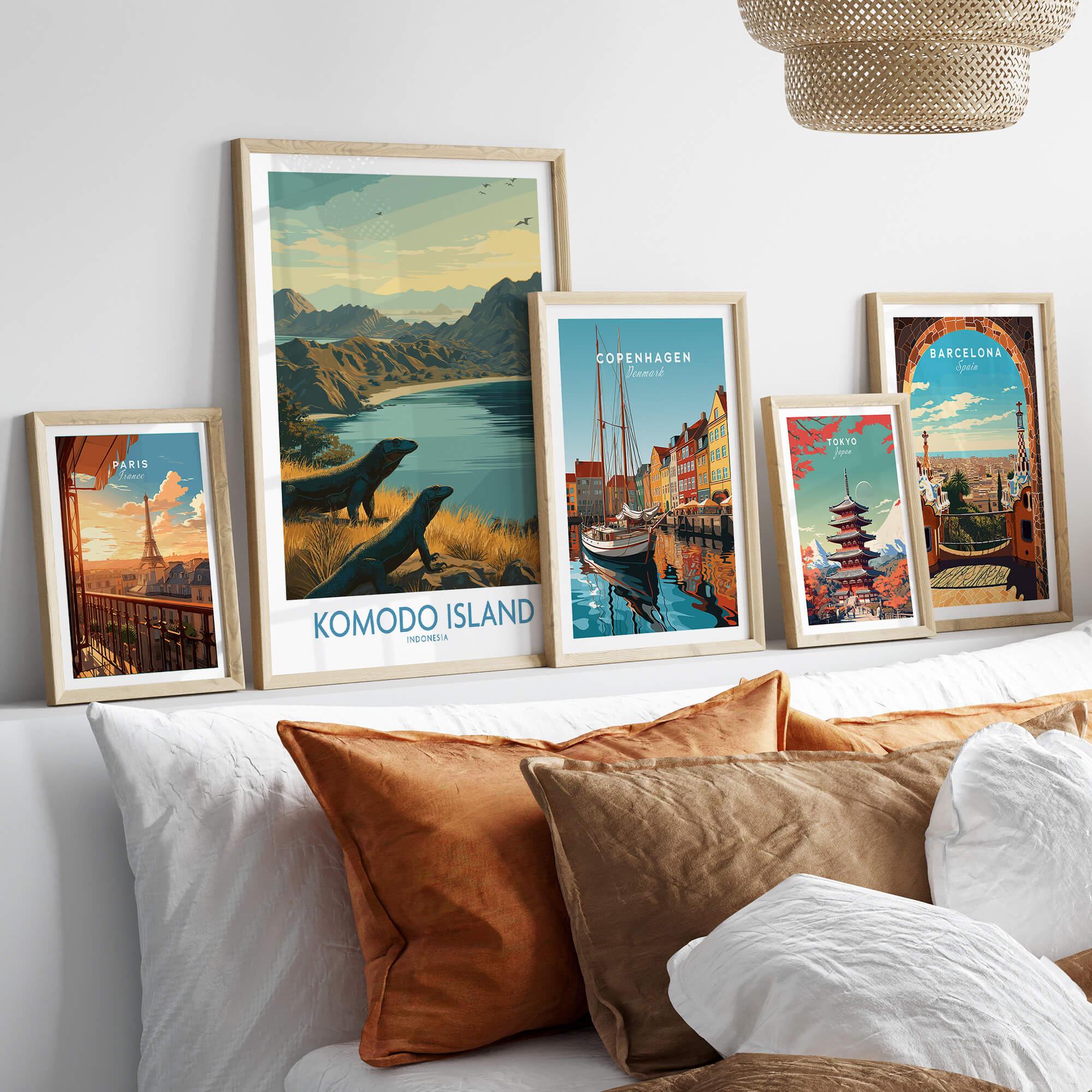 Set of five framed travel posters for Paris, Komodo Island, Copenhagen, Tokyo, and Barcelona above a bed.