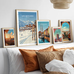 Framed travel posters of Paris, Les Menuires, Copenhagen, Tokyo, and Barcelona above a bed