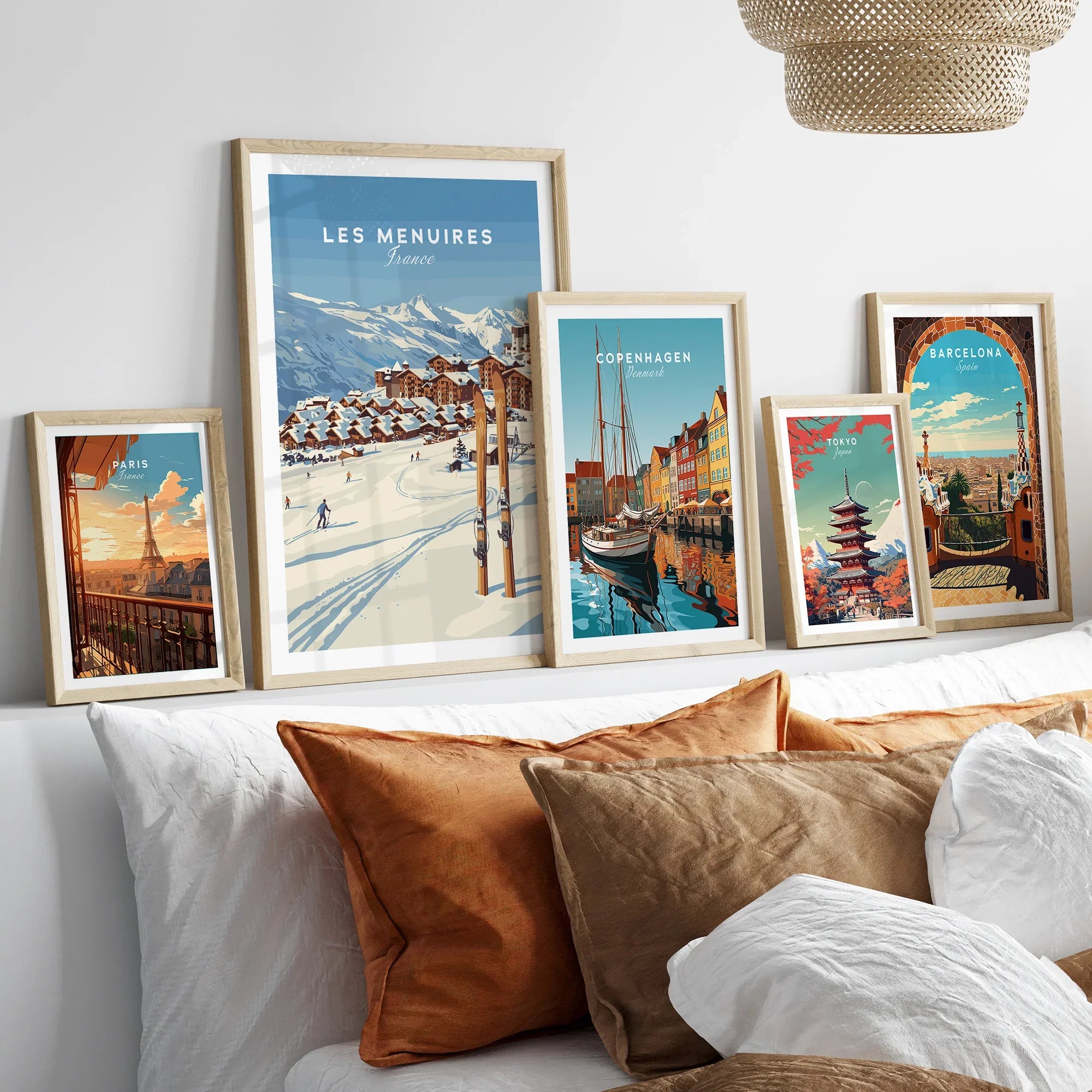 Framed travel posters of Paris, Les Menuires, Copenhagen, Tokyo, and Barcelona above a bed