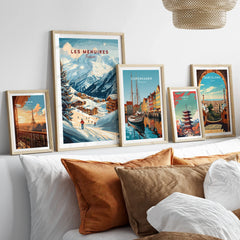 Framed travel posters of Paris, Les Menuires, Copenhagen, Tokyo, and Barcelona above bed