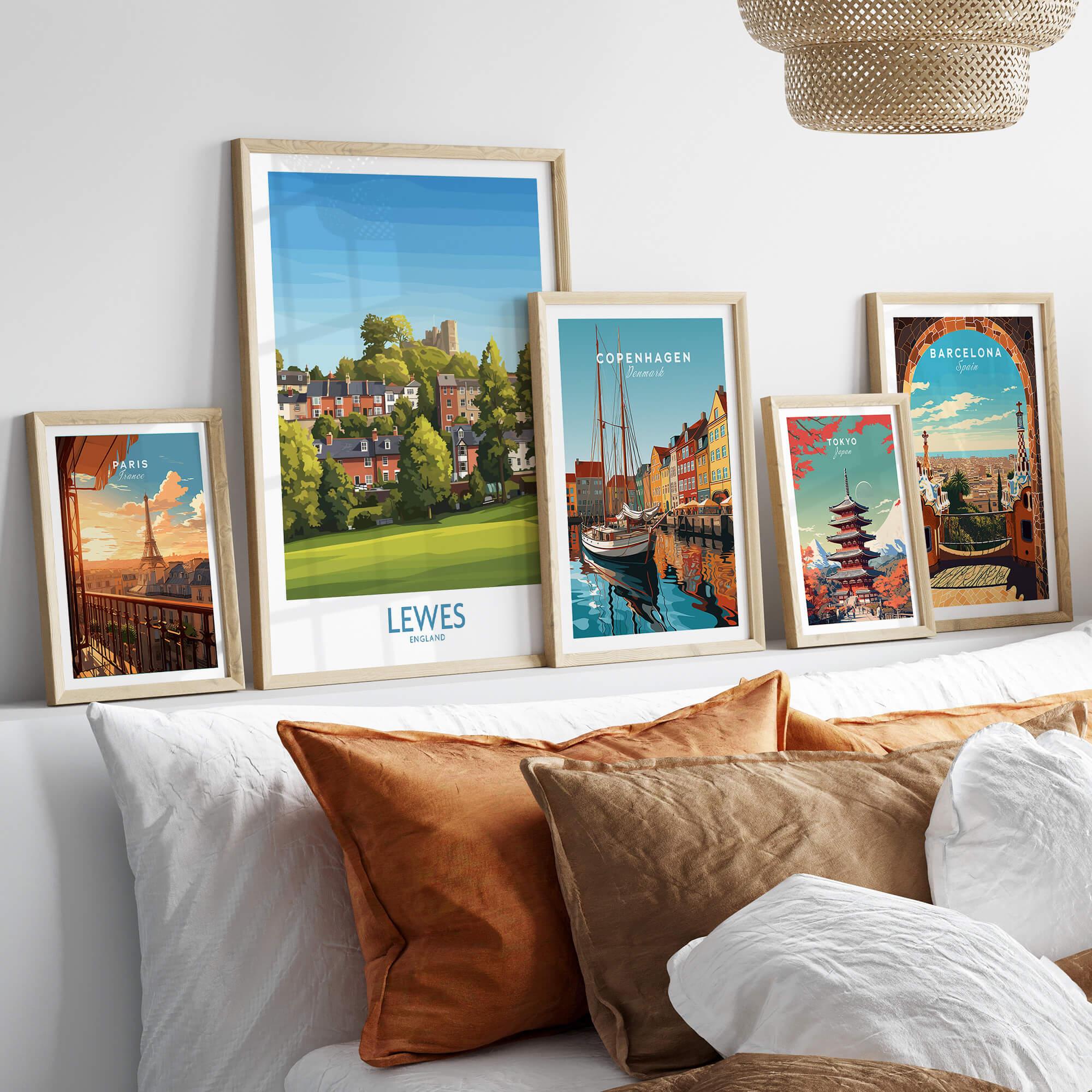Five framed travel posters of global cities above a bed with natural wood frames.