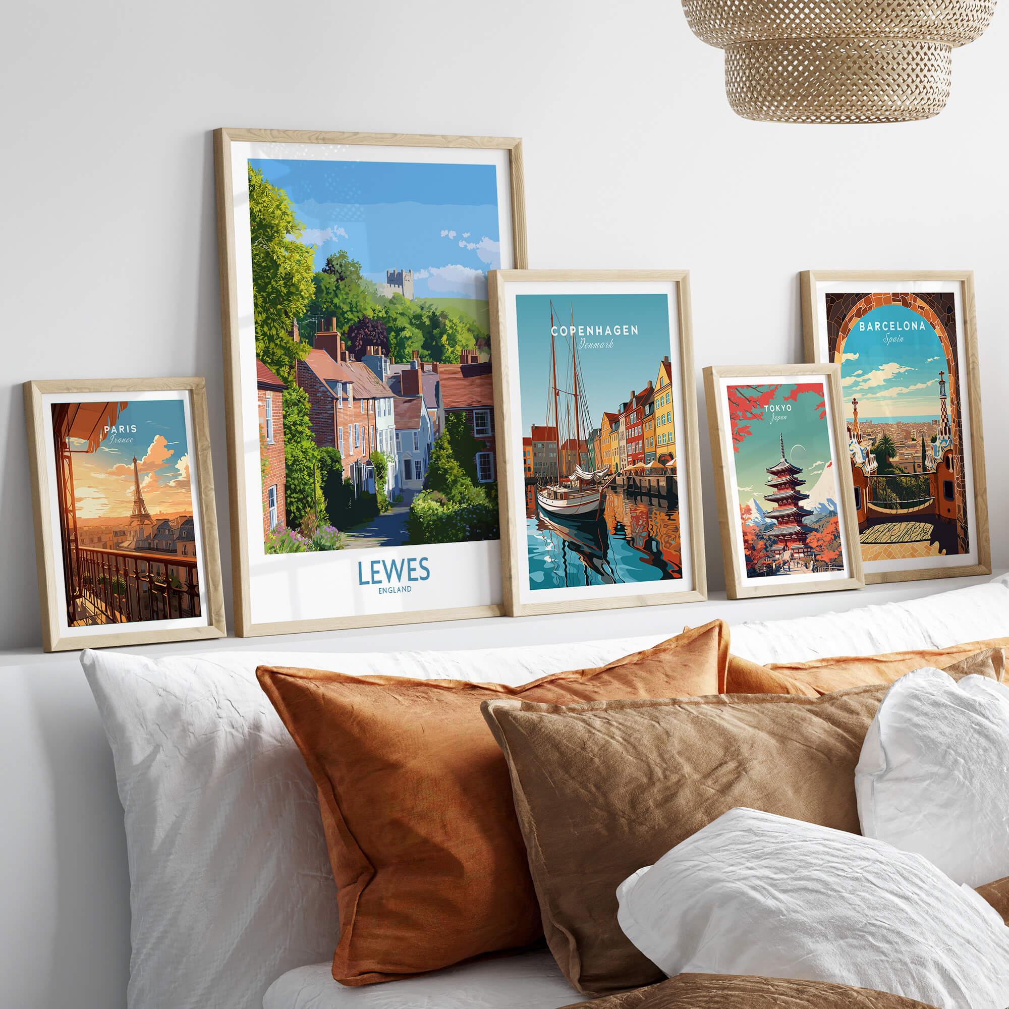 Five framed travel posters with city landmarks above bed, neutral wood frames, cozy decor