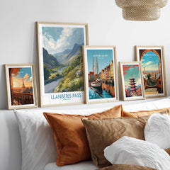 Framed travel posters of Llanberis Pass, Paris, Copenhagen, Tokyo and Barcelona above a bed