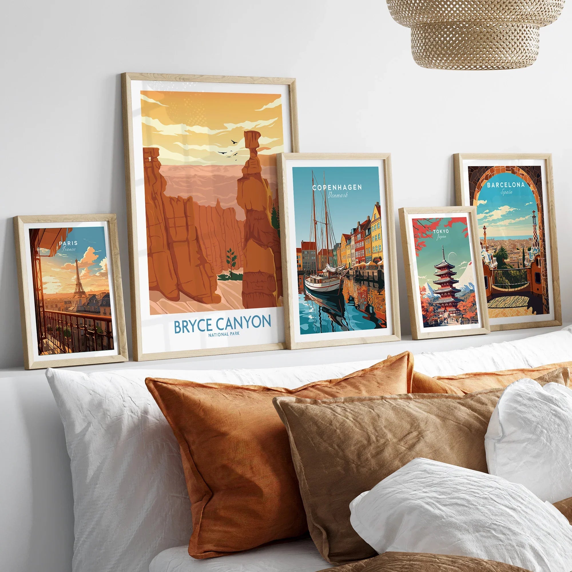 Five framed travel posters above bed featuring Bryce Canyon, Paris, Copenhagen, Tokyo, Barcelona.