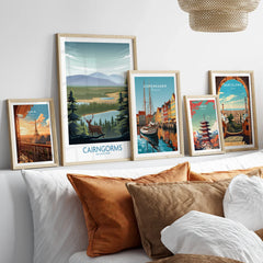 Set of five framed travel art prints above bed, featuring Paris, Cairngorms, Copenhagen, Tokyo, Barcelona.