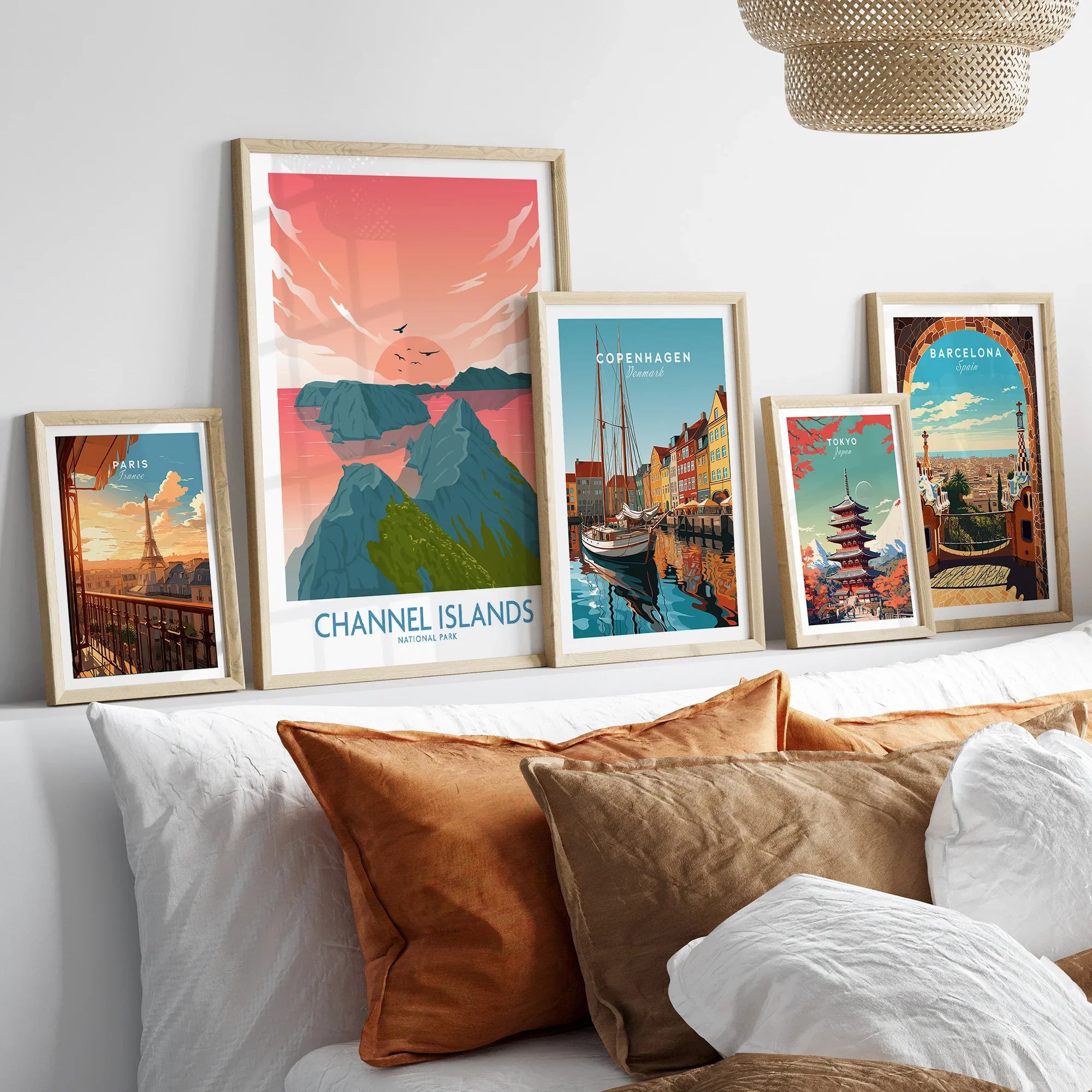 Set of five framed travel and city posters above bed with natural wood frames, home decor