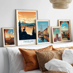 Set of five framed travel posters above bed, featuring Crater Lake, Paris, Copenhagen, Tokyo, Barcelona.