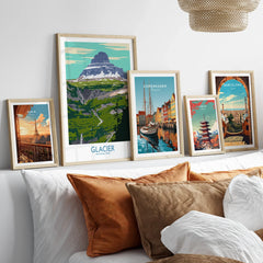 Framed travel art prints of Paris, Glacier National Park, Copenhagen, Tokyo, and Barcelona above bed
