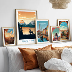 Framed travel posters of Grand Teton, Paris, Copenhagen, Tokyo, and Barcelona above bed