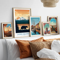 Set of five framed travel and city wall art prints above bed with natural wood frames
