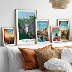 Set of five framed travel art prints above bed featuring Yellowstone, Paris, Copenhagen, Tokyo, Barcelona.