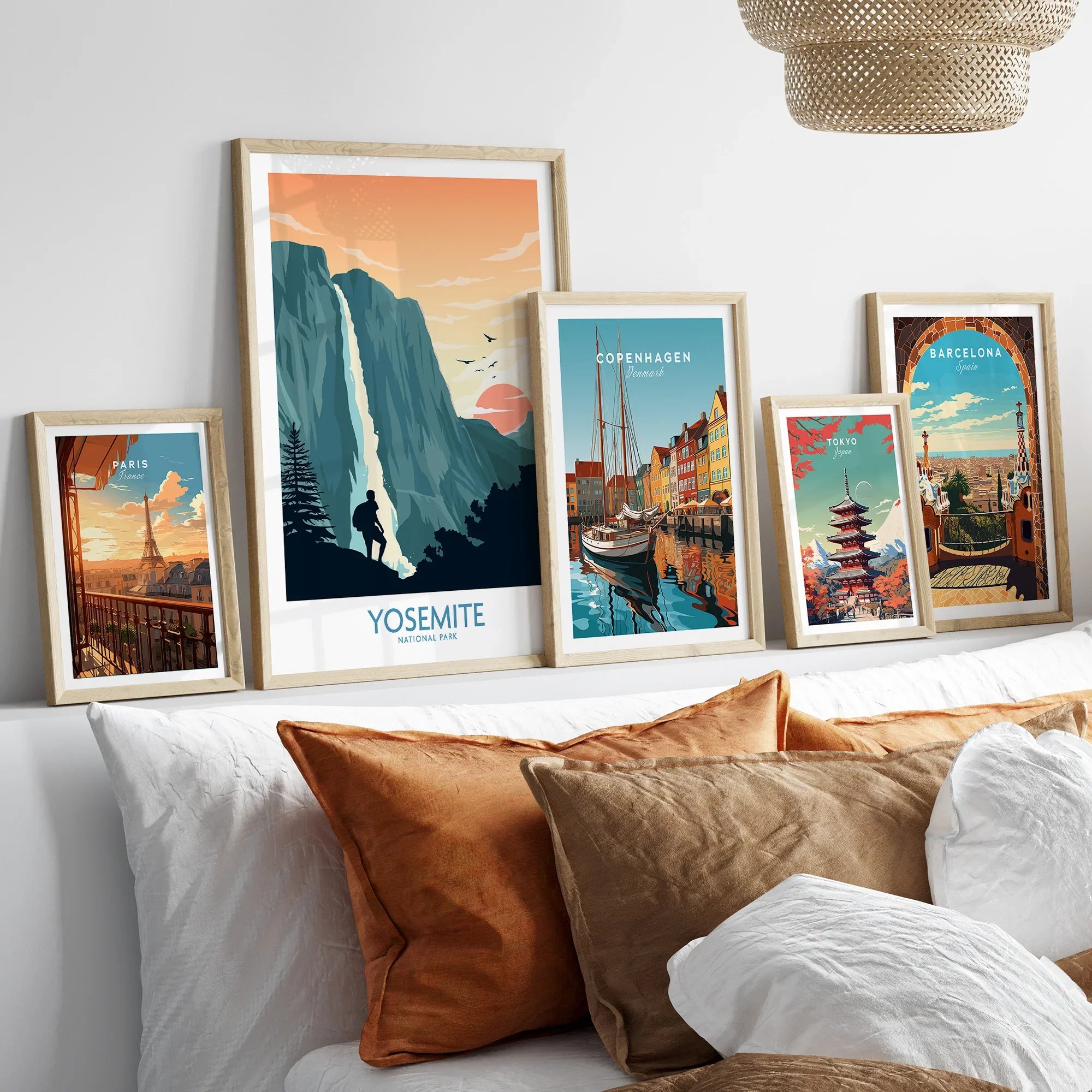 Set of five framed travel posters above bed, featuring Yosemite, Paris, Copenhagen, Tokyo, Barcelona.