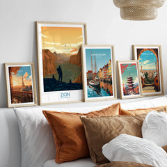 Framed travel posters of Zion National Park, Paris, Copenhagen, Tokyo, and Barcelona above bed