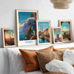 Framed travel posters of Paris, Madeira, Copenhagen, Tokyo, and Barcelona above a bed