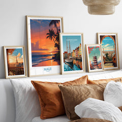 Maui Hawaii Poster | Vibrant Island Coastline Scene Canvas Print displayed among other travel posters on a stylish couch.